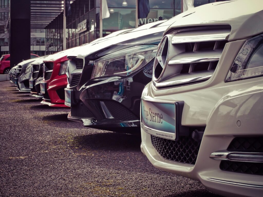pexels-photo-164634-164634 Luxury cars lined up at an outdoor dealership, showcasing sleek designs.